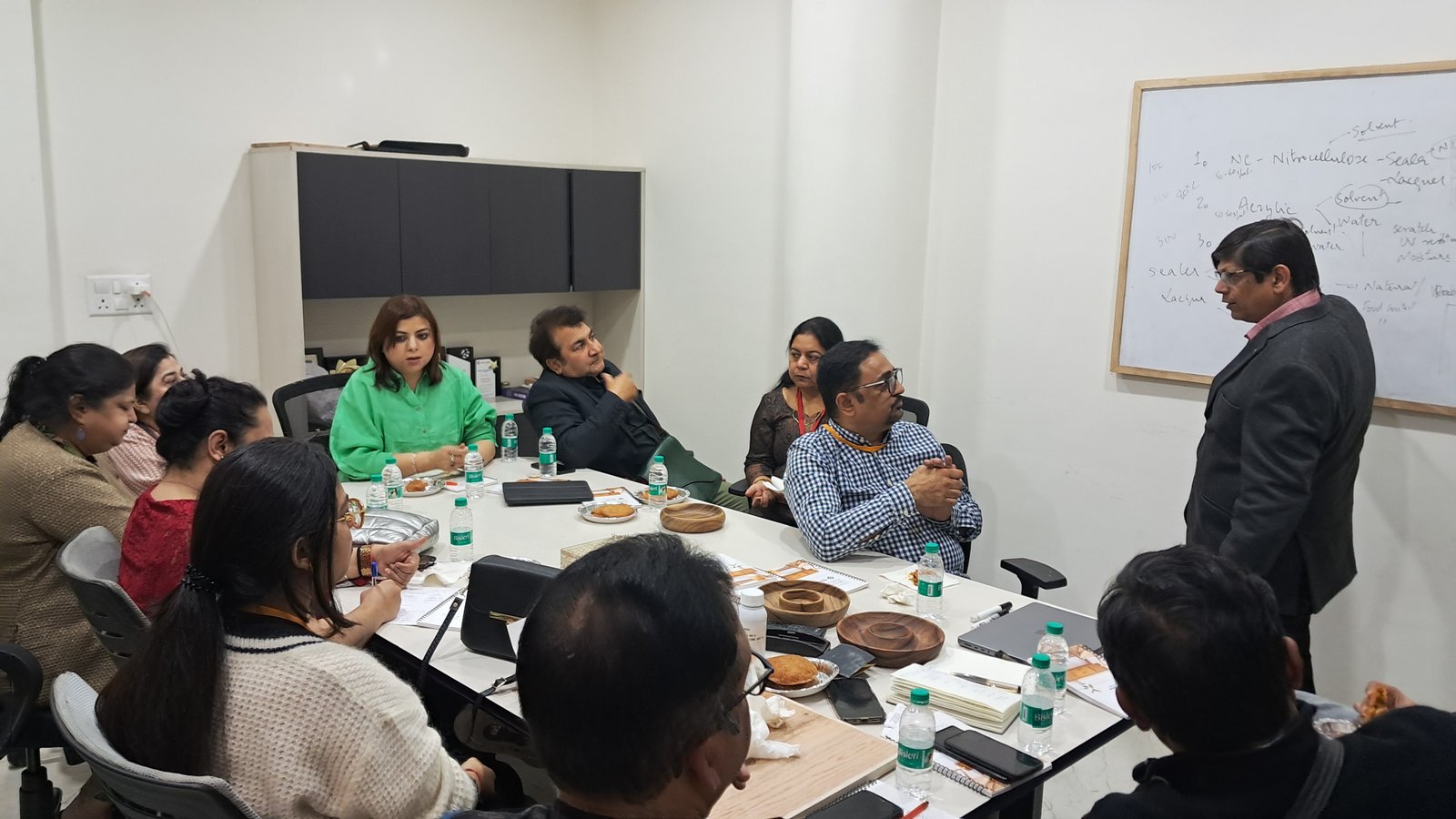 SPA members in a product development discussion around a whiteboard